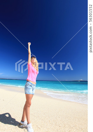 A woman relaxing on the beautiful beach of Tropical Okinawa A woman relaxing on the beautiful beach of Tropical Okinawa 56301552