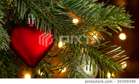 Christmas composition, ball and other decorations on the branches of a Christmas tree on a dark 56309340