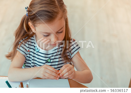 Nice cute girl holding a piece of modeling clay Nice cute girl holding a piece of modeling clay 56336517