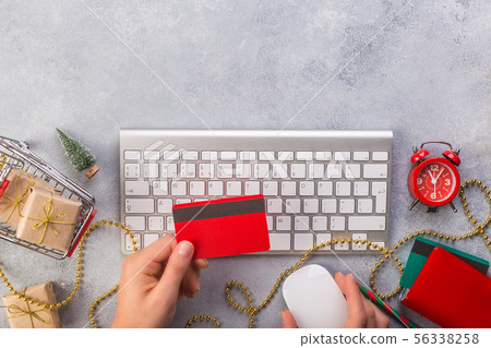 Woman hands paying with credit card. Top view of online christmas gifts online - online shopping 56338258