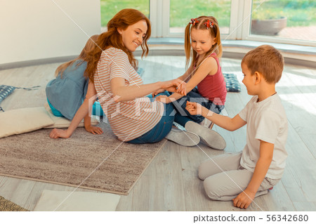 Joyful nice woman playing together with children 56342680