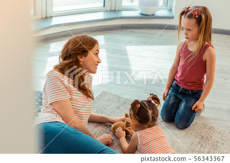 Positive friendly woman looking at the girl 56343367