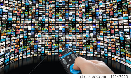 Image of large screen with many channels, hands of man with remote control. Image of large screen with many channels, hands of man with remote control. 56347903
