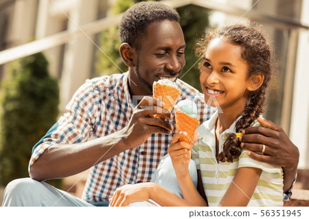 Cheerful longhaired girl listening to her father 56351945