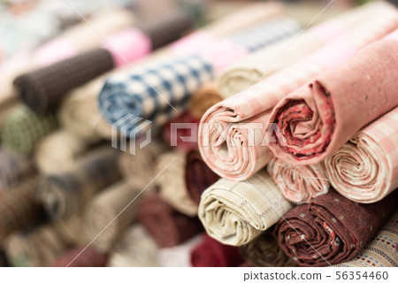 background of colorful fabric stacks 56354460