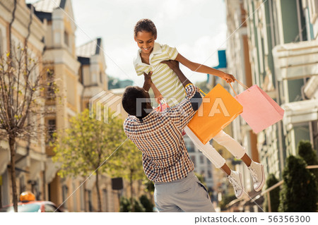 Cheerful little female feeling happiness during family walk 56356300