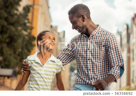 Joyful young man embracing his cute daughter Joyful young man embracing his cute daughter 56356692