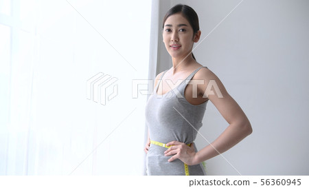 Healthy concept. Asian girls are measuring her 56360945