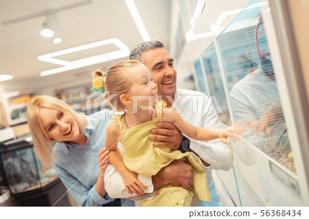 Girl while visiting aquarium with mommy and daddy 56368434