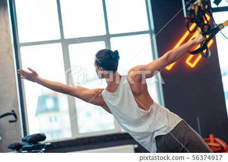 Fit young man having a strength training 56374917