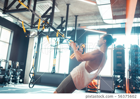 Handsome confident man working out in the gym 56375602