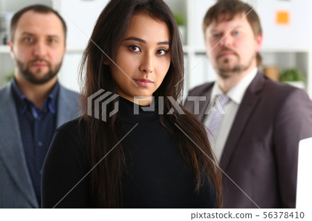 portrait of young successful businesslady hold laptop and two businessmen in office portrait of young successful businesslady hold laptop and two businessmen in office 56378410
