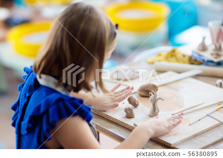 Child at pottery wheel. Kids arts and crafts class 56380895