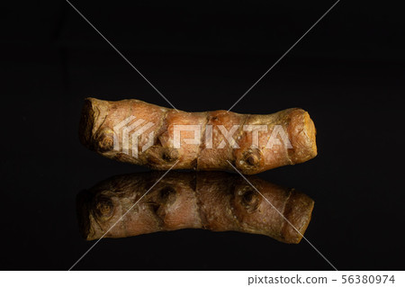 Bright turmeric rhizome isolated on black glass 56380974