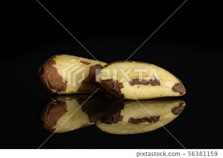 Unshelled brazil nut isolated on black glass Unshelled brazil nut isolated on black glass 56381159
