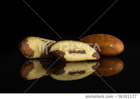 Unshelled brazil nut isolated on black glass Unshelled brazil nut isolated on black glass 56381177