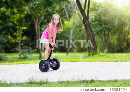 Child on hover board. Kids riding scooter 56381404