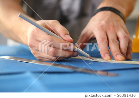 Male hand holding pencil in hand. 56381436