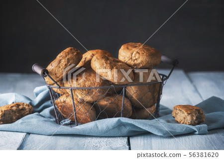 Basket with bread buns on a kitchen table Basket with bread buns on a kitchen table 56381620