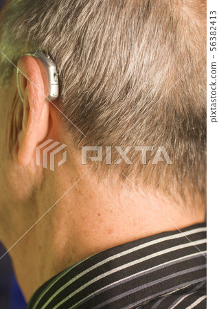 Man with hearing aid Man with hearing aid 56382413