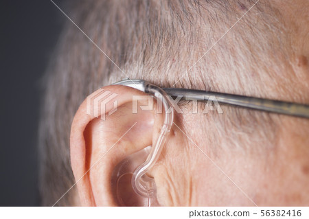 Man with hearing aid Man with hearing aid 56382416