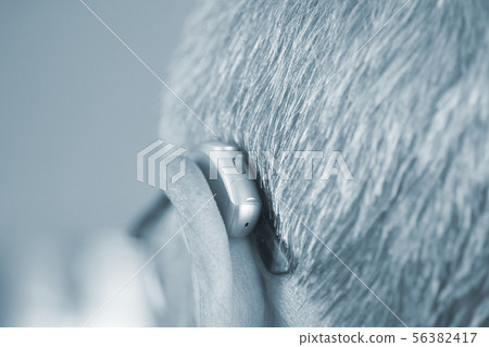 Man with hearing aid Man with hearing aid 56382417