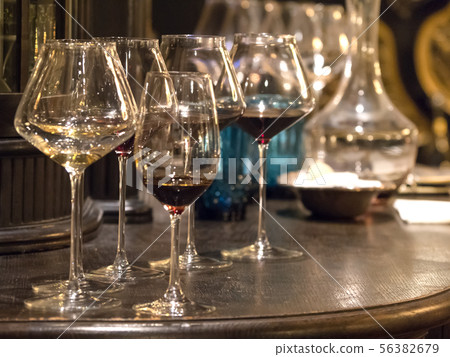 Glasses of elite wine on the bar in dark interior Glasses of elite wine on the bar in dark interior 56382679