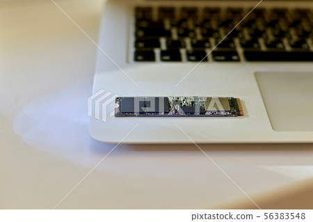 Chip SSD drive on a laptop in a neutral color. Chip SSD drive on a laptop in a neutral color. 56383548