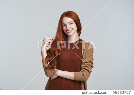 Natural beauty. Portrait of cheerful and cute young redhead lady in casual clothing smiling at Natural beauty. Portrait of cheerful and cute young redhead lady in casual clothing smiling at 56383707