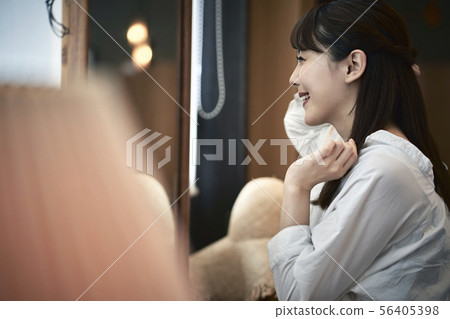 A woman in front of a mirror 56405398