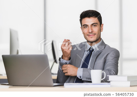Businessman touch his wrist in modern office. 56405730