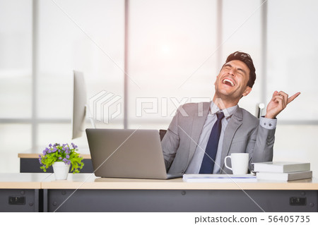 Caucasian businessman laughing in office.. 56405735