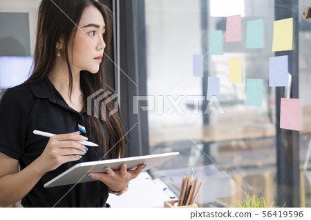 Young businesswoman using tablet searching Young businesswoman using tablet searching 56419596