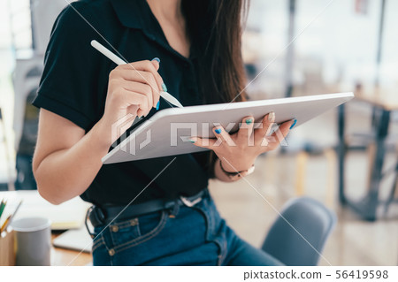 Young businesswoman using tablet searching Young businesswoman using tablet searching 56419598