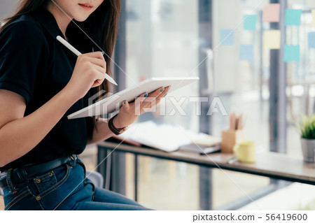 Young businesswoman using tablet searching Young businesswoman using tablet searching 56419600