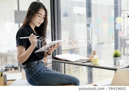 Young businesswoman using tablet searching Young businesswoman using tablet searching 56419602