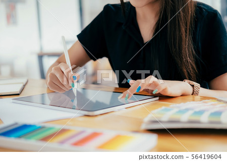 Graphic designer working at her desk in creative 56419604