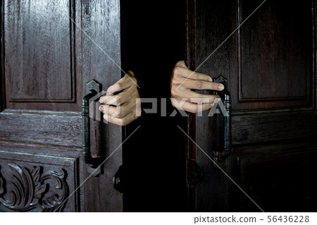 Hands open the wooden door from the inside of the Hands open the wooden door from the inside of the 56436228