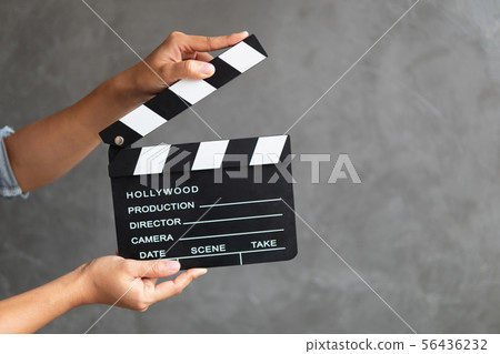 Women hands holding clapper board for making video Women hands holding clapper board for making video 56436232