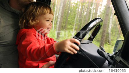 Happy little kid driving car with father Happy little kid driving car with father 56439063
