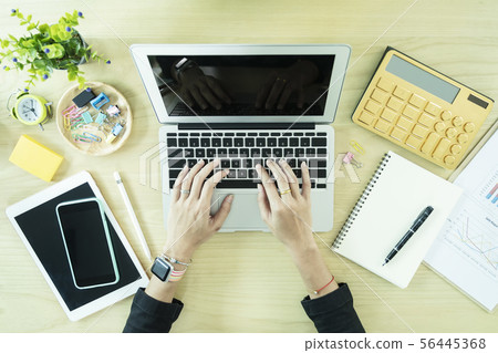 Closeup of hand working with laptop, tablet, 56445368