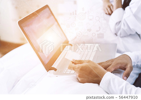 Husband hand holding a credit card and using a 56447910