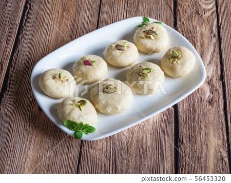 Pedha (Indian sweet), Milk Fudge in a brown wooden 56453320