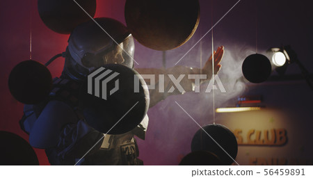 Student in space suit looking at planet models 56459891