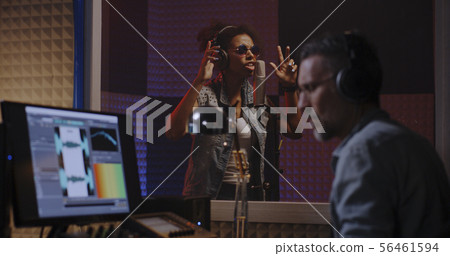 Vocalist and sound engineer working in studio Vocalist and sound engineer working in studio 56461594
