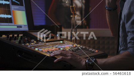 Sound engineer working with mixing console Sound engineer working with mixing console 56461618