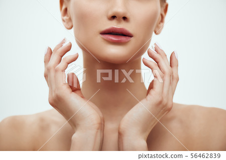 Pure beauty. Cropped photo of young blonde woman touching her soft and fresh skin while standing Pure beauty. Cropped photo of young blonde woman touching her soft and fresh skin while standing 56462839