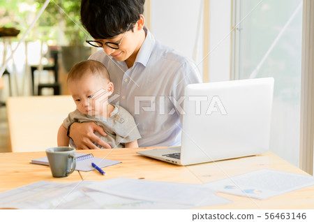 Men who work while holding a child Men who work while holding a child 56463146