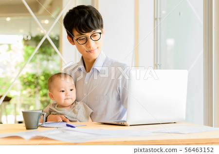 在抱孩子的同時工作的男人 在抱孩子的同時工作的男人 56463152