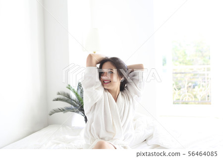Portrait of beautiful woman in white bathrobe in Portrait of beautiful woman in white bathrobe in 56464085